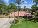 Charming single-story home with well-maintained lawn, palm trees, and American flag at 7507 Beasley Rd, Tampa, FL 33615