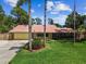Charming single-story home with well-maintained lawn, palm trees, and American flag at 7507 Beasley Rd, Tampa, FL 33615
