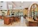 Open kitchen with a large island, tiled flooring, and natural light at 7507 Beasley Rd, Tampa, FL 33615