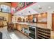 Kitchen island with bar seating, wine fridge, sink, and stainless steel appliances at 7507 Beasley Rd, Tampa, FL 33615