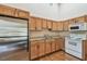 Cozy kitchen features oak cabinets, stainless steel refrigerator, and white appliances at 7507 Beasley Rd, Tampa, FL 33615