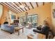 Spacious living room with vaulted ceilings, tile floors, and access to a patio at 7507 Beasley Rd, Tampa, FL 33615