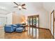 Bright living room featuring wood flooring, and large windows with natural light at 7507 Beasley Rd, Tampa, FL 33615