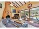 Stylish living room featuring tile flooring, a fireplace and views of the screened-in pool at 7507 Beasley Rd, Tampa, FL 33615
