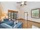 Bright living room featuring wood flooring, and large windows with natural light at 7507 Beasley Rd, Tampa, FL 33615