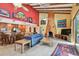 Open concept living room and kitchen featuring vaulted ceilings and unique decor at 7507 Beasley Rd, Tampa, FL 33615