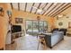 Bright living room boasts vaulted ceilings, tile floors, and views of the outdoor pool at 7507 Beasley Rd, Tampa, FL 33615