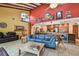 Open floor plan showcasing the living room and kitchen with warm colors and tile floors at 7507 Beasley Rd, Tampa, FL 33615