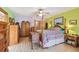 Main bedroom featuring wood floors, four-poster bed, ceiling fan and bright, modern paint colors at 7507 Beasley Rd, Tampa, FL 33615