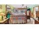 Stylishly decorated main bedroom with a four-poster bed, dresser, and access to the outdoor pool area at 7507 Beasley Rd, Tampa, FL 33615