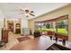 Comfortable home office with built-in seating, ceiling fan, view of front yard, and tile flooring at 7507 Beasley Rd, Tampa, FL 33615