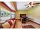 Sunny office with large window seat, built in desk, ceiling fan and a view of the lush front yard at 7507 Beasley Rd, Tampa, FL 33615