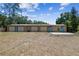 Spacious outbuilding with four garage doors set on a large grass lot at 7507 Beasley Rd, Tampa, FL 33615