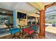 Outdoor patio featuring a mounted TV, cozy seating, and easy access to a screened pool at 7507 Beasley Rd, Tampa, FL 33615