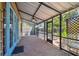 Spacious screened-in patio with brick flooring and ceiling fan at 7507 Beasley Rd, Tampa, FL 33615