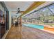 Spacious covered patio featuring ceiling fans and overlooking a screened-in pool and landscaped backyard at 7507 Beasley Rd, Tampa, FL 33615