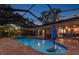 Beautiful screened-in pool and lanai with an umbrella-covered island in the water, perfect for relaxation at 7507 Beasley Rd, Tampa, FL 33615