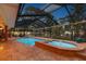 Relaxing screened-in pool area with attached spa and beautifully landscaped backyard, perfect for outdoor enjoyment at 7507 Beasley Rd, Tampa, FL 33615