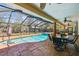 Covered patio with a clear view of a pool and green landscaping, perfect for outdoor relaxation at 7507 Beasley Rd, Tampa, FL 33615