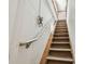 Stairway leading to an upper level, featuring white walls and wooden steps at 7507 Beasley Rd, Tampa, FL 33615