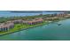 Aerial view of waterfront condominium complex with private dock, pool, and lush landscaping at 7520 Sunshine Skyway S Ln # 109, St Petersburg, FL 33711