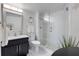 Elegant bathroom features a glass enclosed shower and modern vanity with black hardware at 7520 Sunshine Skyway S Ln # 109, St Petersburg, FL 33711