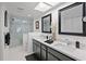 Bright bathroom with double sinks, a glass enclosed shower, and modern fixtures at 7520 Sunshine Skyway S Ln # 109, St Petersburg, FL 33711