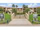 Inviting building entrance with well-manicured landscaping, a central walkway, and signage for the units at 7520 Sunshine Skyway S Ln # 109, St Petersburg, FL 33711