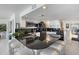 Open kitchen featuring black countertops, white cabinets, stainless appliances, and bar seating at 7520 Sunshine Skyway S Ln # 109, St Petersburg, FL 33711