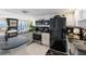 Modern kitchen with black countertops, stainless steel appliances, and a view of the living area and water at 7520 Sunshine Skyway S Ln # 109, St Petersburg, FL 33711
