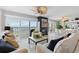 Bright living room featuring modern decor, a fireplace, and large windows with stunning water views at 7520 Sunshine Skyway S Ln # 109, St Petersburg, FL 33711
