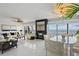 Elegant living room with tile flooring, a fireplace, water views, and an adjacent dining area at 7520 Sunshine Skyway S Ln # 109, St Petersburg, FL 33711