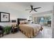 This gorgeous main bedroom features water views, tile floors, and a ceiling fan at 7520 Sunshine Skyway S Ln # 109, St Petersburg, FL 33711