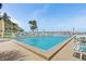 Inviting community swimming pool with lounge chairs and palm trees, perfect for relaxation at 7520 Sunshine Skyway S Ln # 109, St Petersburg, FL 33711