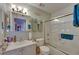 Well-lit bathroom featuring a shower and bathtub combination with decorative towel racks at 9481 Highland Oak Dr # 1511, Tampa, FL 33647