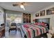 Cozy bedroom features a ceiling fan, large window, and art hanging above the bed at 9481 Highland Oak Dr # 1511, Tampa, FL 33647