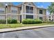 Exterior view of the building shows the screened balcony, and manicured landscaping at 9481 Highland Oak Dr # 1511, Tampa, FL 33647