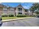 Exterior view of the building shows the screened balcony, and manicured landscaping at 9481 Highland Oak Dr # 1511, Tampa, FL 33647