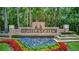 Hunter's Green community sign surrounded by colorful flowers and manicured greenery at 9481 Highland Oak Dr # 1511, Tampa, FL 33647