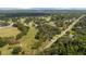 Aerial view of golf course and community surrounded by lush greenery and mature trees at 9542 Wallien Dr, Brooksville, FL 34601