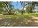 Spacious, well-maintained backyard with mature trees providing shade at 9542 Wallien Dr, Brooksville, FL 34601