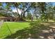 Manicured backyard with an abundance of green space, creating an ideal space for outdoor activities at 9542 Wallien Dr, Brooksville, FL 34601