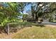 Lush backyard with mature trees, a fence, and a view of the home at 9542 Wallien Dr, Brooksville, FL 34601