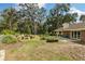 Charming backyard featuring a cozy fire pit and a well-maintained garden at 9542 Wallien Dr, Brooksville, FL 34601