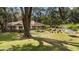 An inviting backyard space with a hammock, mature trees and a cozy seating area at 9542 Wallien Dr, Brooksville, FL 34601