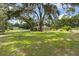 Large backyard with mature trees and ample green space at 9542 Wallien Dr, Brooksville, FL 34601
