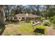 Backyard with hammock, mature trees, garden boxes, and lush grass at 9542 Wallien Dr, Brooksville, FL 34601
