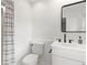 Well-lit bathroom showcases a vanity, toilet, and shower with curtain at 9542 Wallien Dr, Brooksville, FL 34601