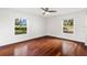 Bedroom featuring hardwood floors, bright natural light, and two windows at 9542 Wallien Dr, Brooksville, FL 34601
