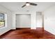 Cozy bedroom features hardwood floors, closet, and window at 9542 Wallien Dr, Brooksville, FL 34601